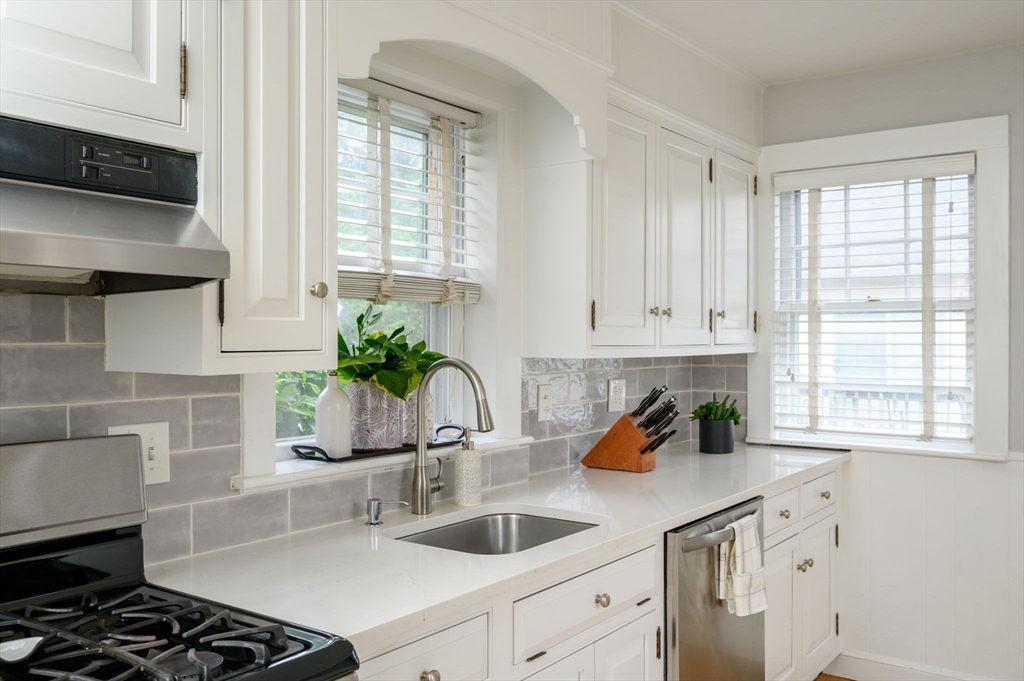 45 Rowe Street Milton, MA 02186 - Photo 4 of 34 a kitchen with white cabinets and a stove
