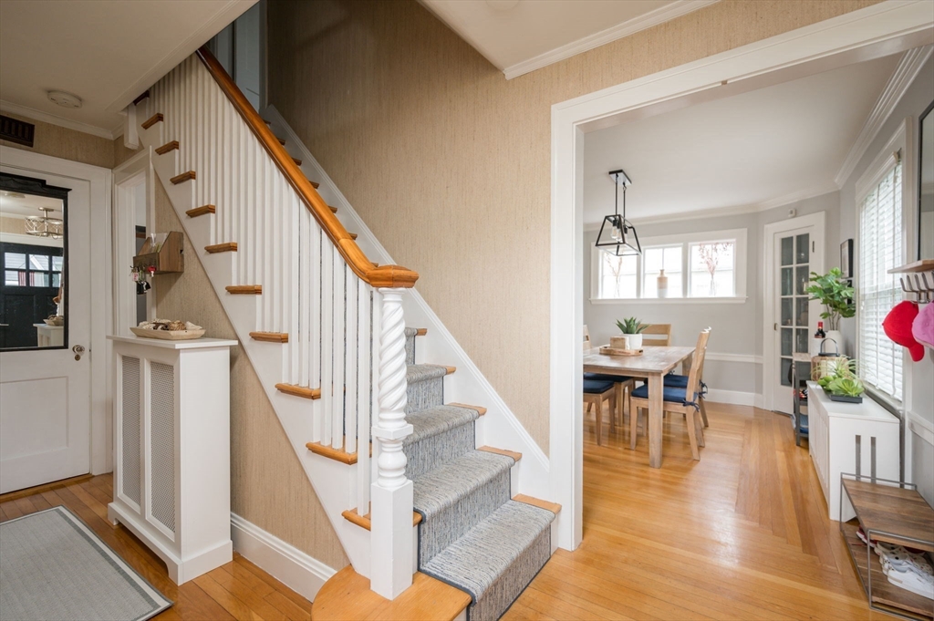 45 Rowe Street Milton, MA 02186 - Photo 8 of 34 a view of entryway livingroom and hall with wooden floor