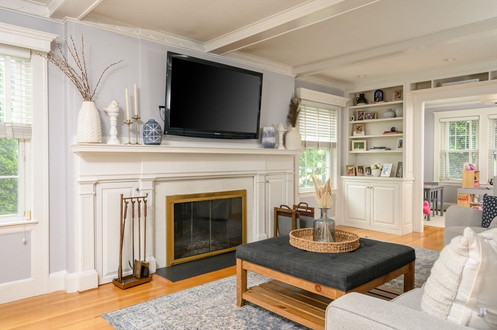45 Rowe Street Milton, MA 02186 - Photo 9 of 34 a living room with furniture a flat screen tv and a fireplace
