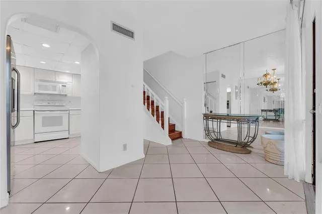 a view of kitchen with furniture and refrigerator