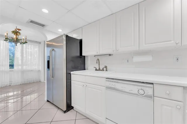 a kitchen with appliances a sink and cabinets