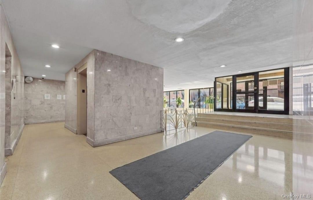 99-35 59th Avenue, Unit 5D Queens, NY 11368 - Photo 2 of 19 a view of a big room with windows and chandelier