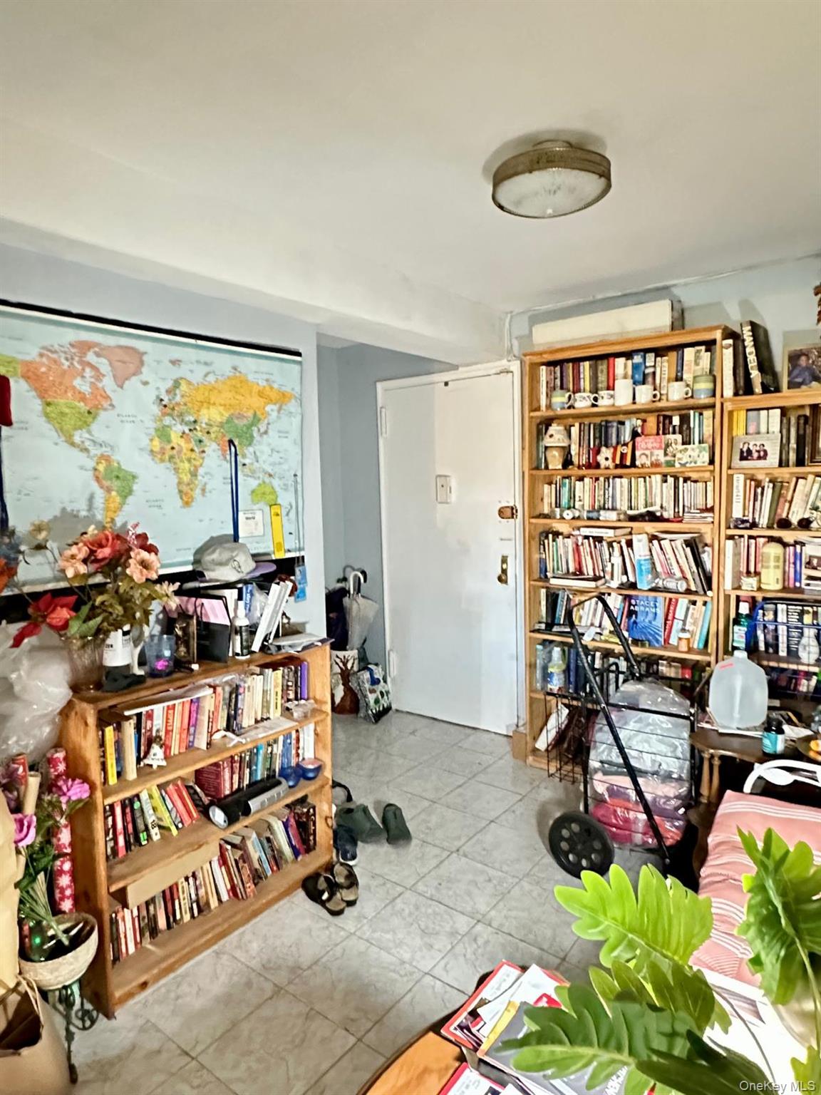 99-35 59th Avenue, Unit 5D Queens, NY 11368 - Photo 4 of 19 a room with musical instruments and air hockey table