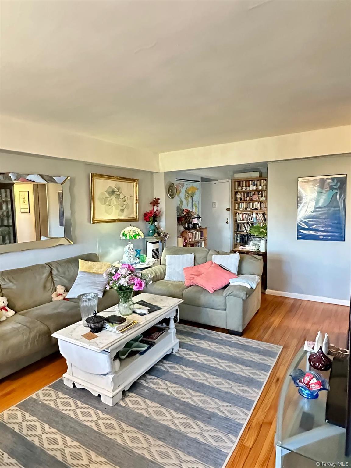 99-35 59th Avenue, Unit 5D Queens, NY 11368 - Photo 6 of 19 a living room with furniture and a couch