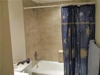 a bathroom with a shower and a sink