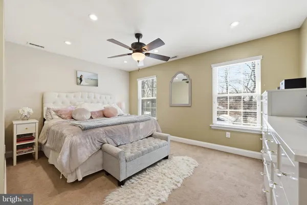 a spacious bedroom with a bed and a window