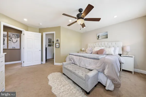 a bed room with a bed and a ceiling fan