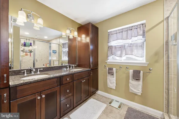 a bathroom with a double vanity sink and a mirror