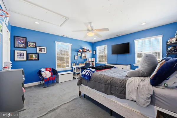 a living room with furniture ceiling fan and a window