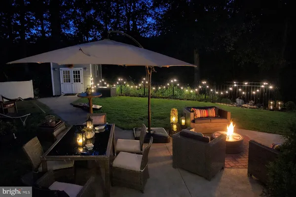 a view of a patio with couches table chairs and a yard