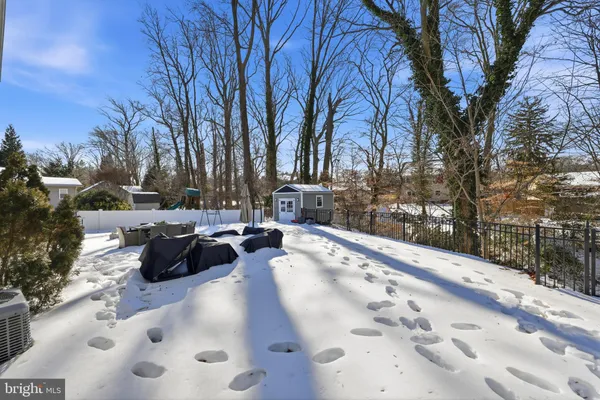 a view of swimming pool with chairs and trees