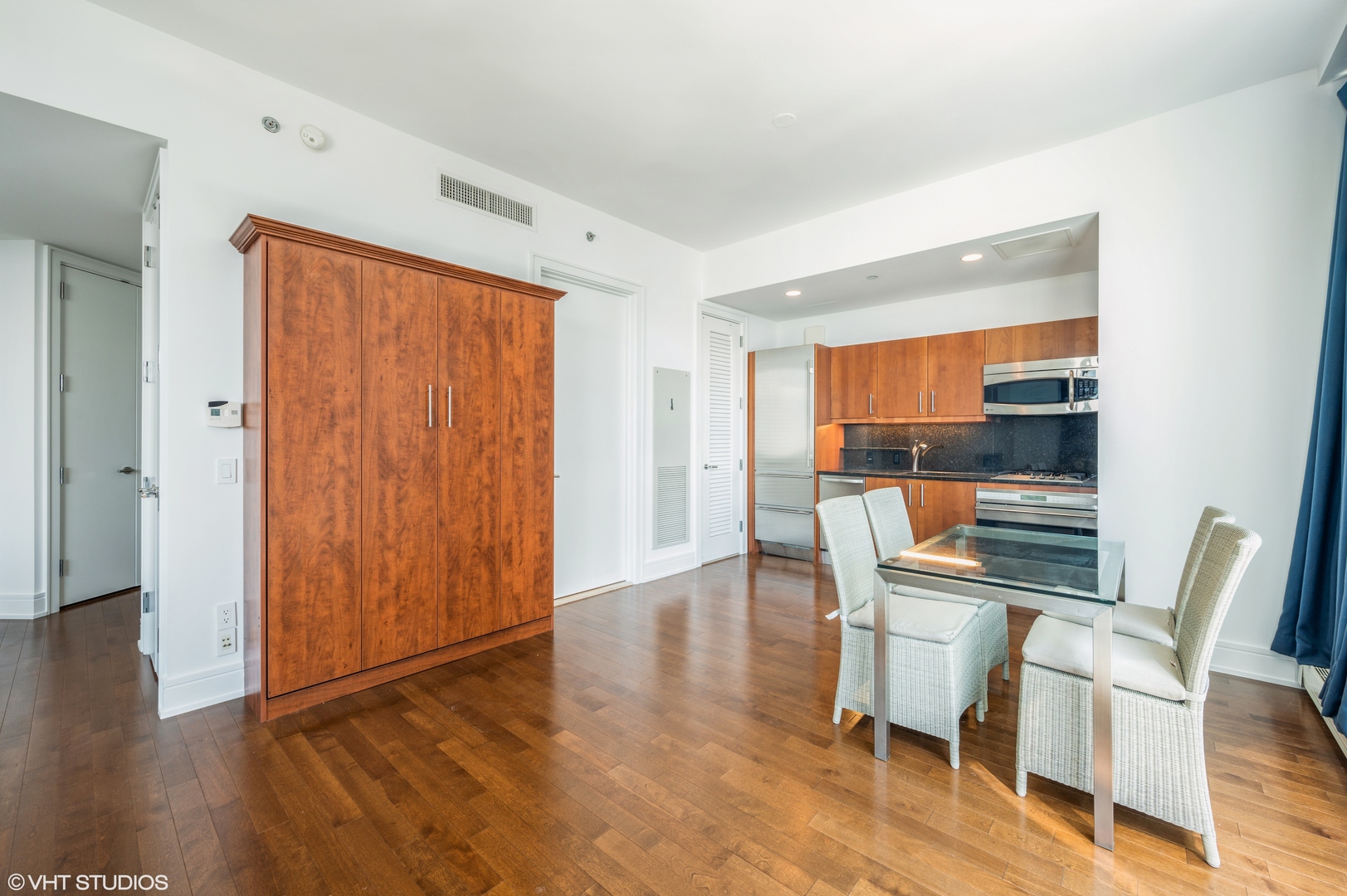 401 North Wabash Avenue, Unit 31F Chicago, IL 60611 - Photo 7 of 13 a dining room with furniture wooden floor and a window