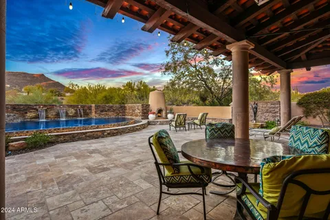 a swimming pool with outdoor seating and yard