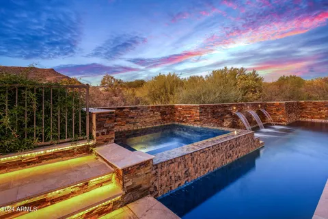a bedroom with a bed television and a large window