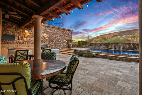 a view of a patio with table and chairs and potted plants