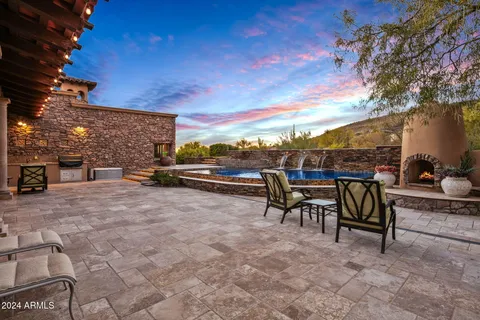 a view of a door of the house with potted plants