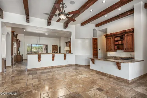 a living room with fireplace furniture and a large window