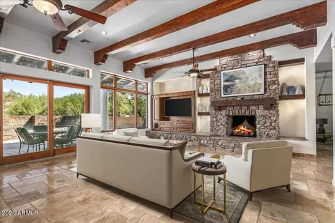 a living room with fireplace furniture and a flat screen tv