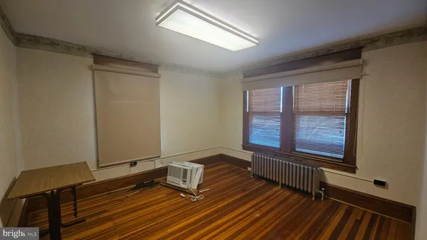 a view of a room with wooden floor