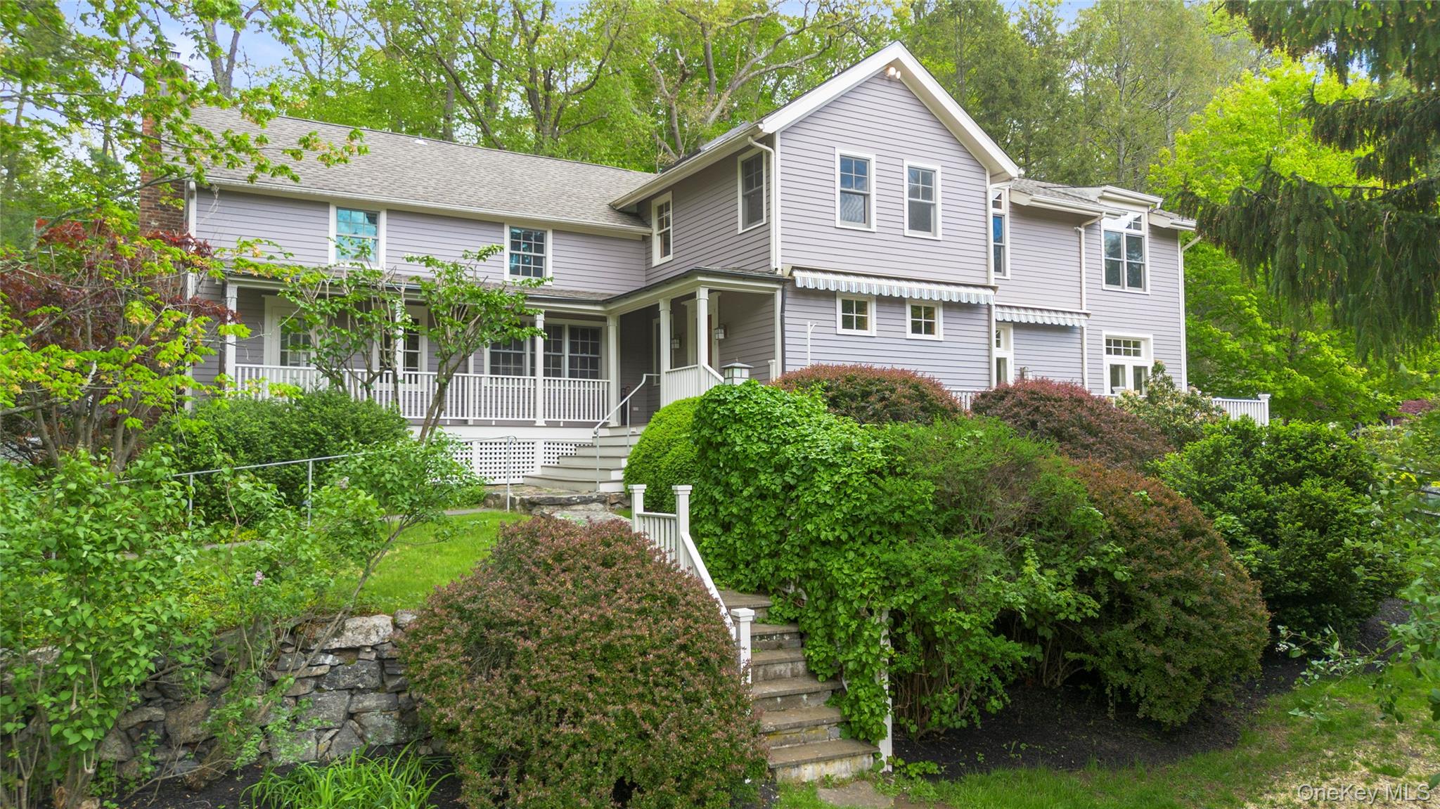 View of front of house featuring stairway and a porch
