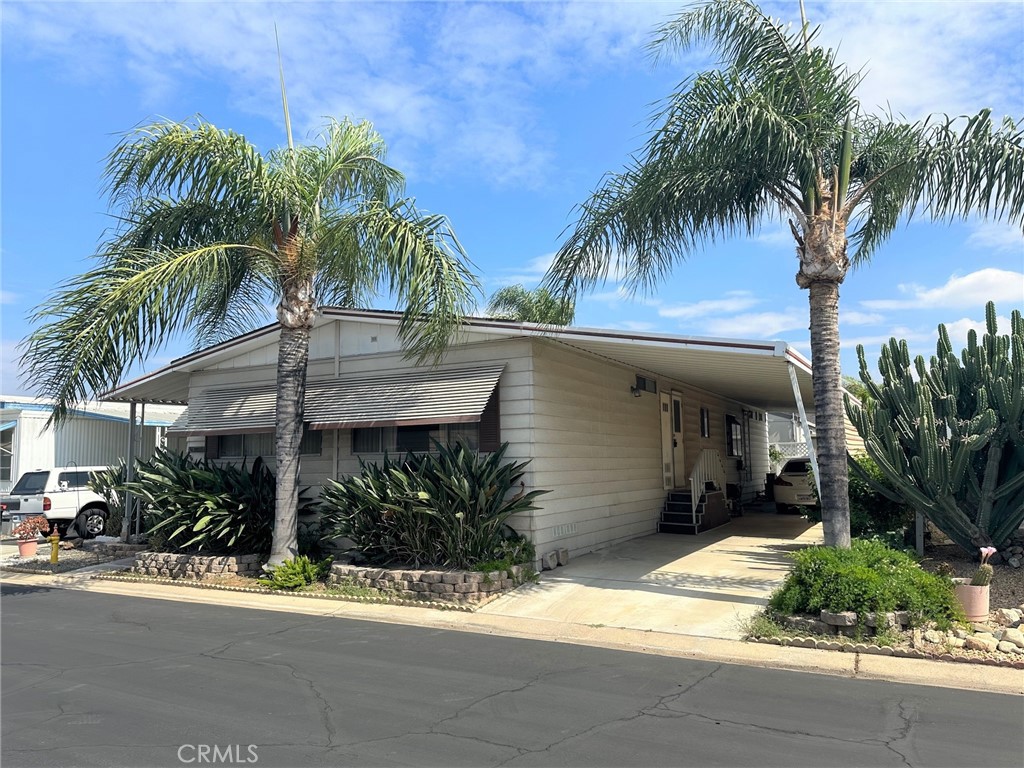 4000 Pierce Street, Unit 260 Riverside, CA 92505 - Photo 1 of 1 a view of a house with a yard and palm trees