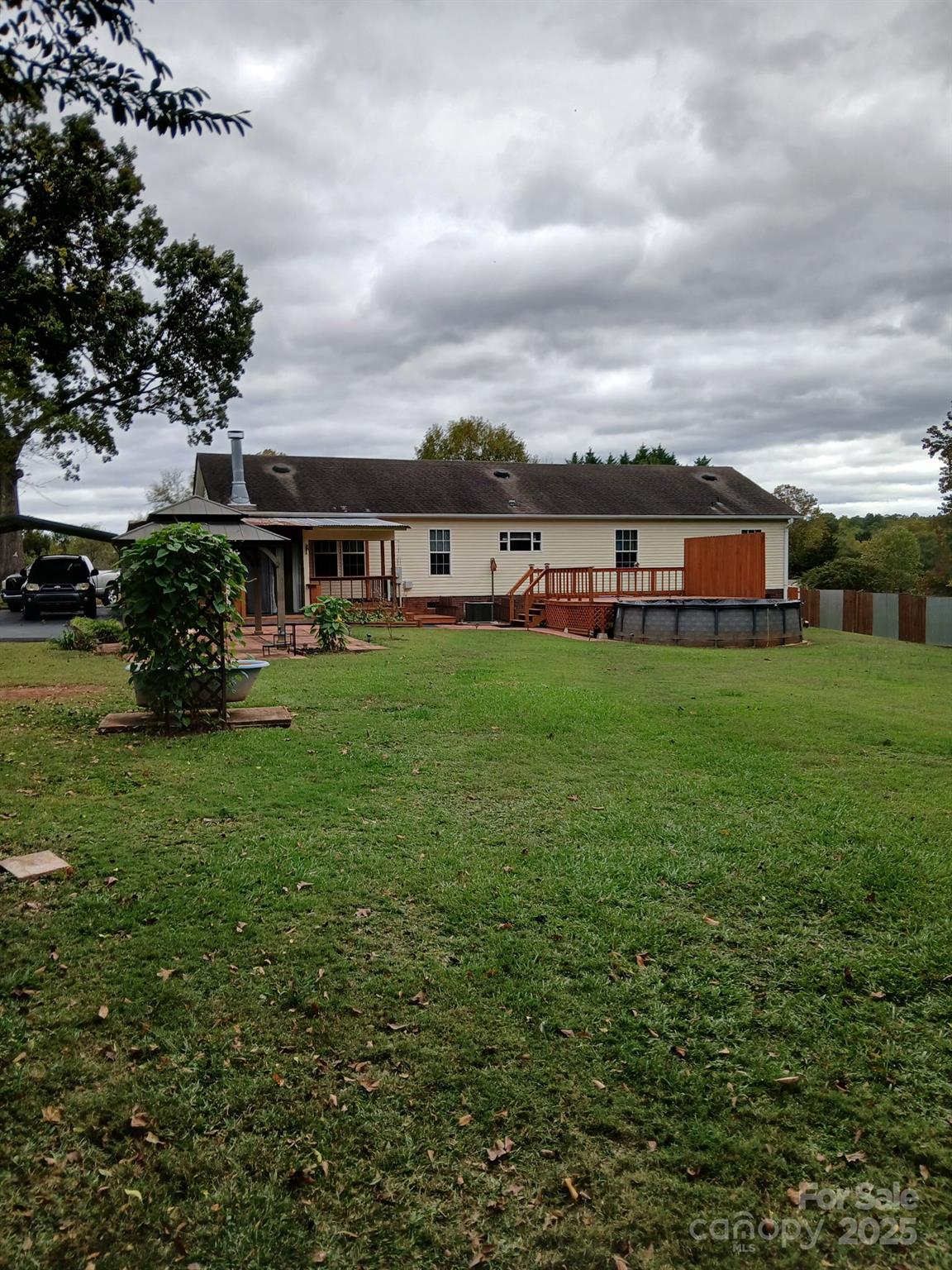 218 Muldoon Lane Clover, SC 29710 - Photo 2 of 26 a view of a house with a big yard and large trees
