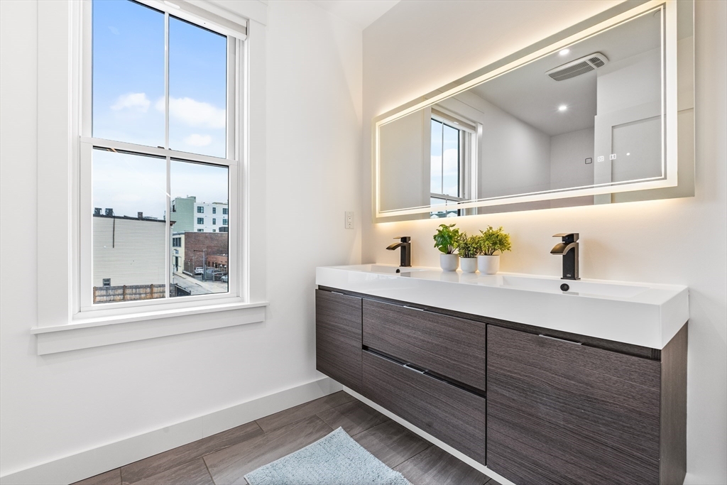 360 Athens Street, Unit 360 Boston, MA 02127 - Photo 11 of 27 a bathroom with a sink and a mirror
