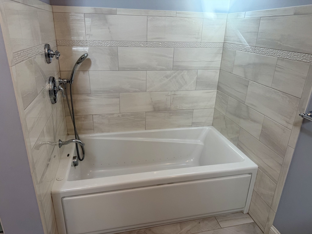 722 Lowell Street, Unit A Peabody, MA 01960 - Photo 26 of 40 a close view of a bathtub in bathroom