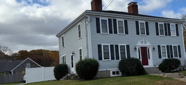 a front view of a house with garden
