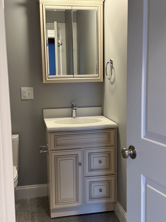 722 Lowell Street, Unit A Peabody, MA 01960 - Photo 31 of 40 a bathroom with a sink and a mirror
