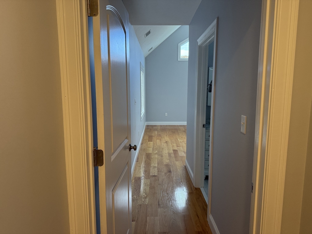 722 Lowell Street, Unit A Peabody, MA 01960 - Photo 33 of 40 a view of a hallway with wooden floor