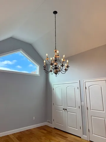 a view of a room with wooden floor