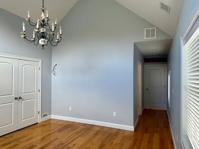 a view of a chandelier fan and wooden floor