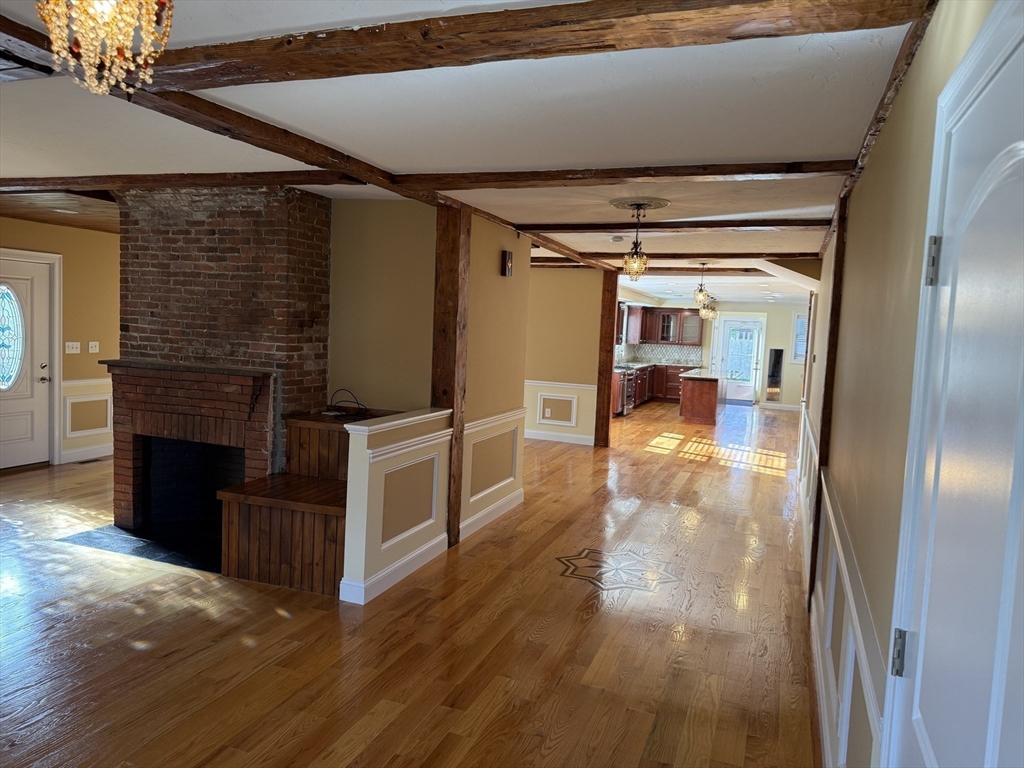 722 Lowell Street, Unit A Peabody, MA 01960 - Photo 5 of 40 a view of a hallway with wooden floor and staircase