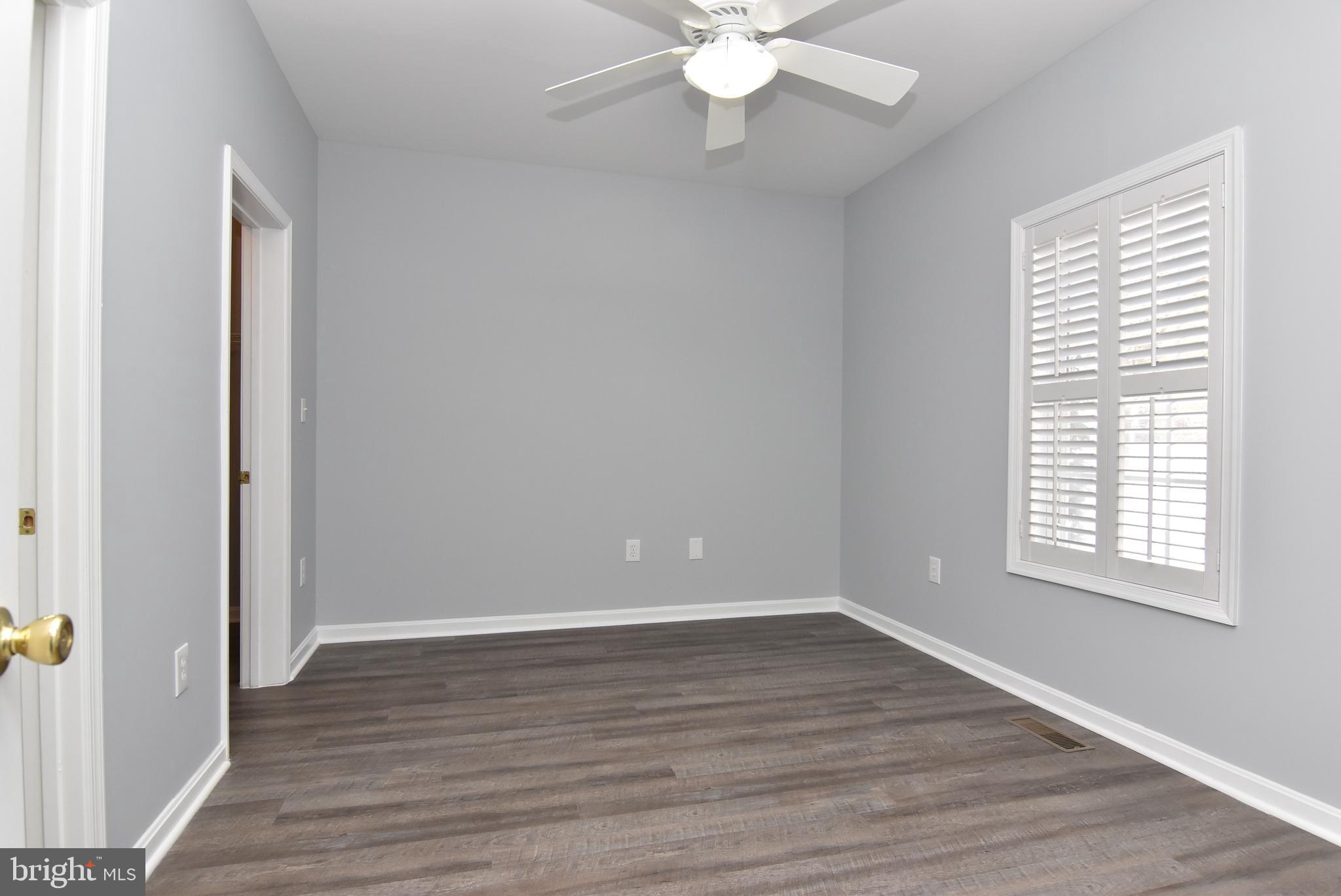 100 Cascade Lane, Unit 101 Rehoboth Beach, DE 19971 - Photo 14 of 26 a view of an empty room with wooden floor and a window