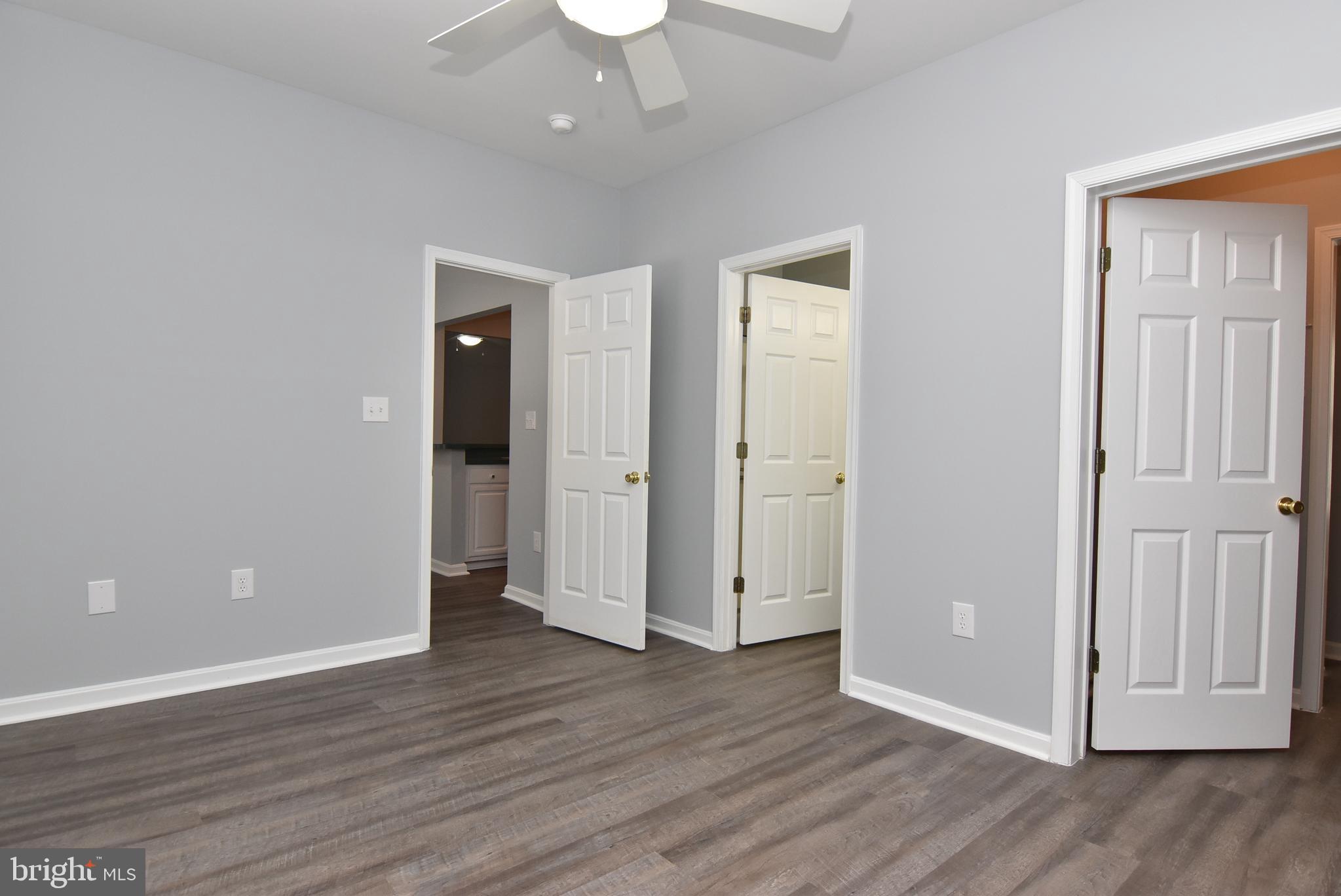 100 Cascade Lane, Unit 101 Rehoboth Beach, DE 19971 - Photo 17 of 26 an empty room with wooden floor and windows