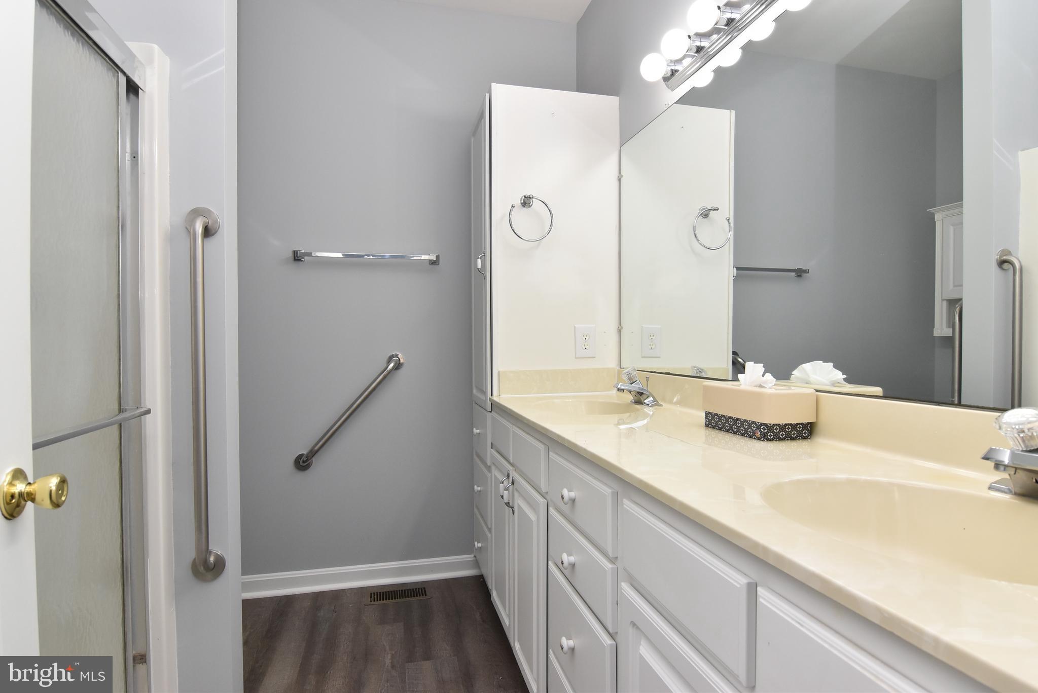100 Cascade Lane, Unit 101 Rehoboth Beach, DE 19971 - Photo 18 of 26 a bathroom with a sink and a mirror