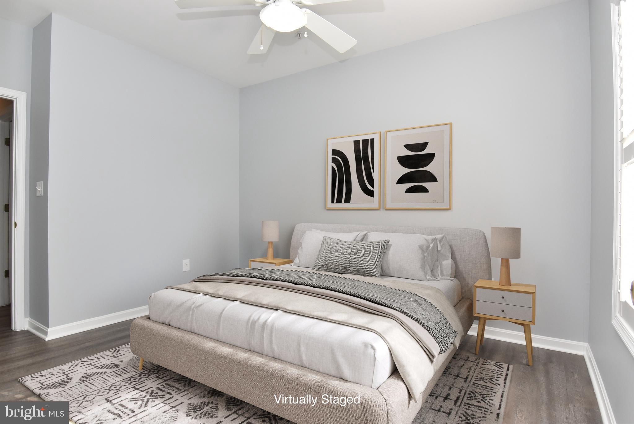 100 Cascade Lane, Unit 101 Rehoboth Beach, DE 19971 - Photo 22 of 26 a bedroom with a bed and a painting on the wall