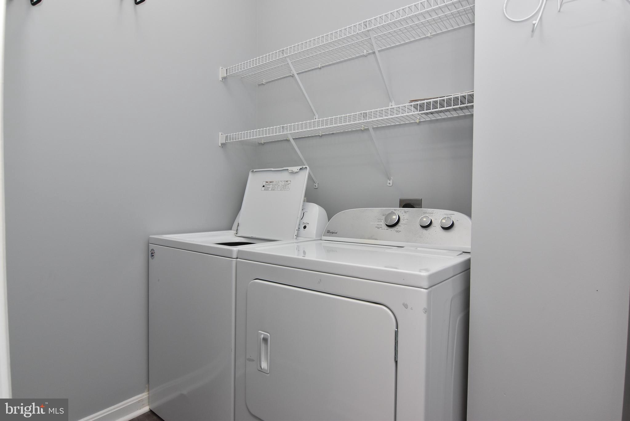 100 Cascade Lane, Unit 101 Rehoboth Beach, DE 19971 - Photo 25 of 26 a utility room with dryer and washer