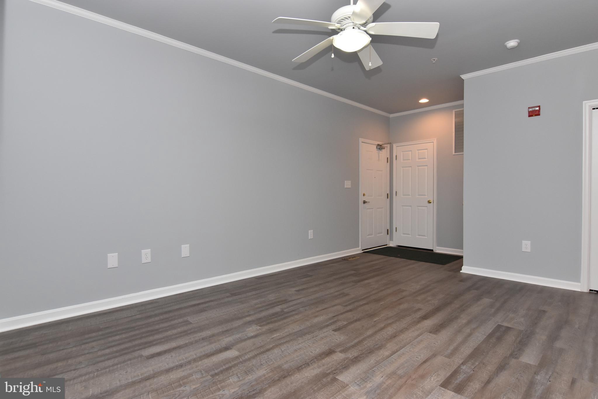 100 Cascade Lane, Unit 101 Rehoboth Beach, DE 19971 - Photo 5 of 26 a view of an empty room with wooden floor
