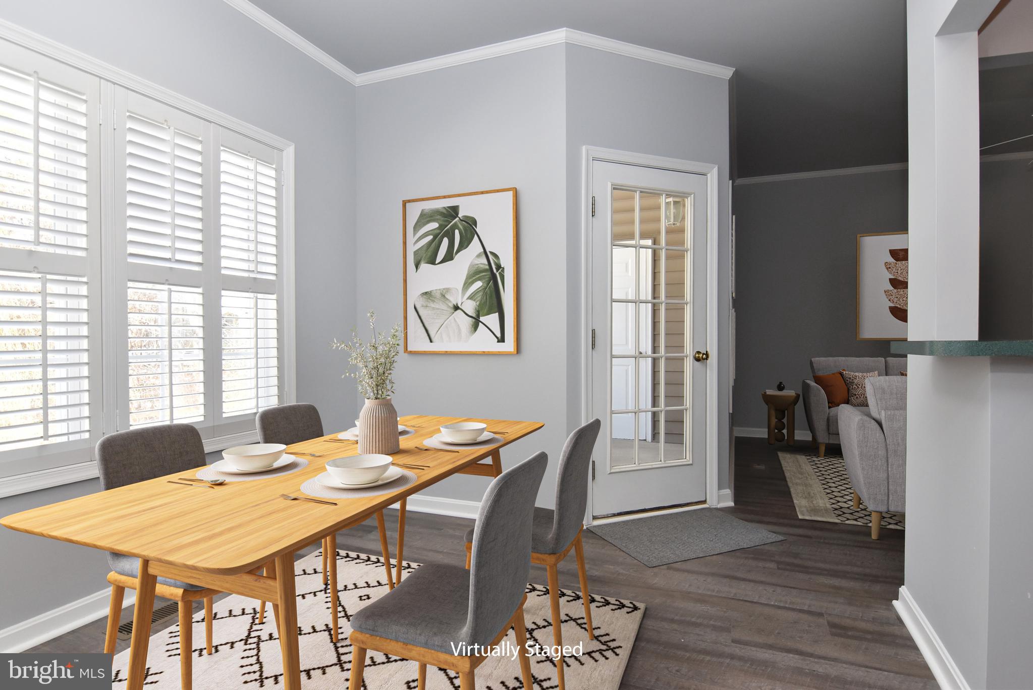 100 Cascade Lane, Unit 101 Rehoboth Beach, DE 19971 - Photo 9 of 26 a view of a dining room with furniture window and wooden floor