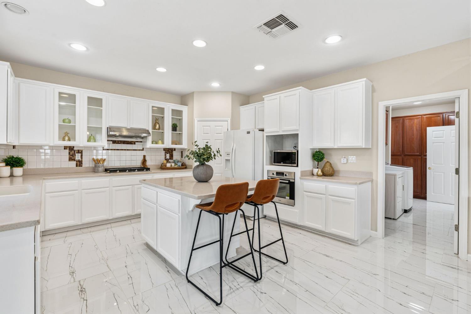 2603 Bellows Street Davis, CA 95618 - Photo 12 of 50 a kitchen with white cabinets and stainless steel appliances