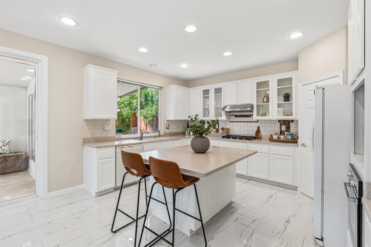 2603 Bellows Street Davis, CA 95618 - Photo 17 of 50 a kitchen with white cabinets and stainless steel appliances