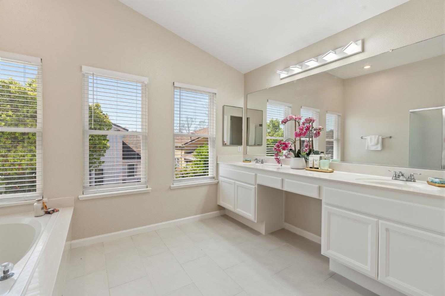 2603 Bellows Street Davis, CA 95618 - Photo 26 of 50 a bathroom with a granite countertop sink mirror and a bathtub