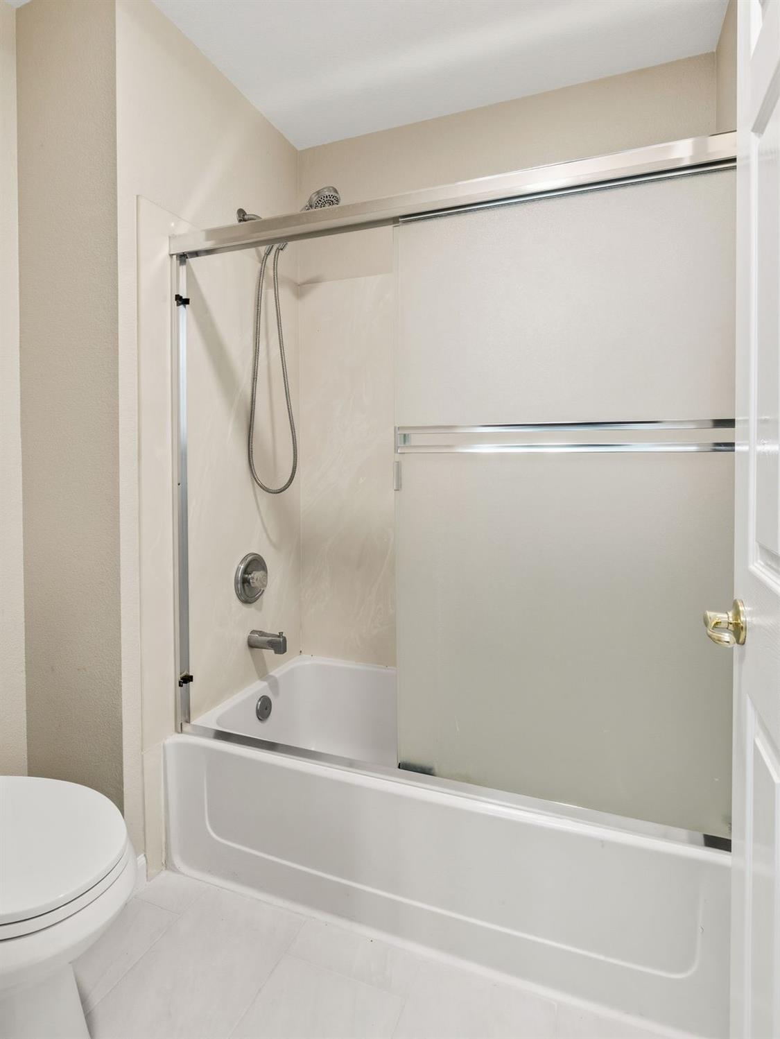 2603 Bellows Street Davis, CA 95618 - Photo 32 of 50 a bathroom with a bathtub and a shower
