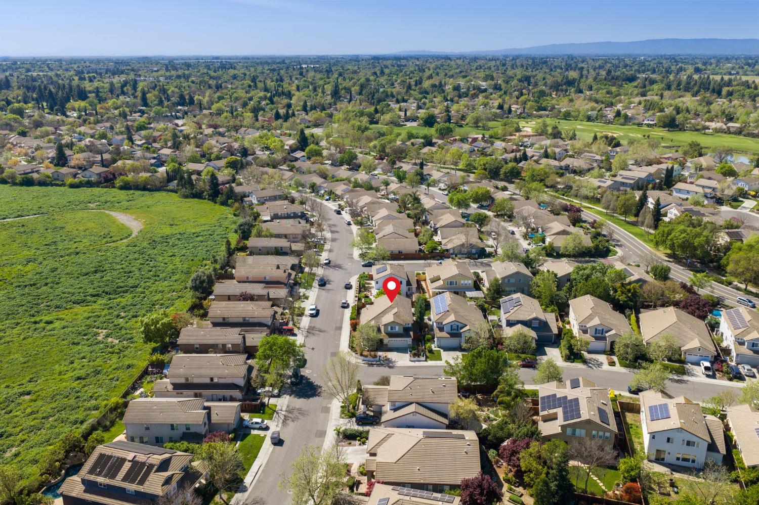2603 Bellows Street Davis, CA 95618 - Photo 46 of 50 an aerial view of a city with lots of residential buildings and mountain view in back