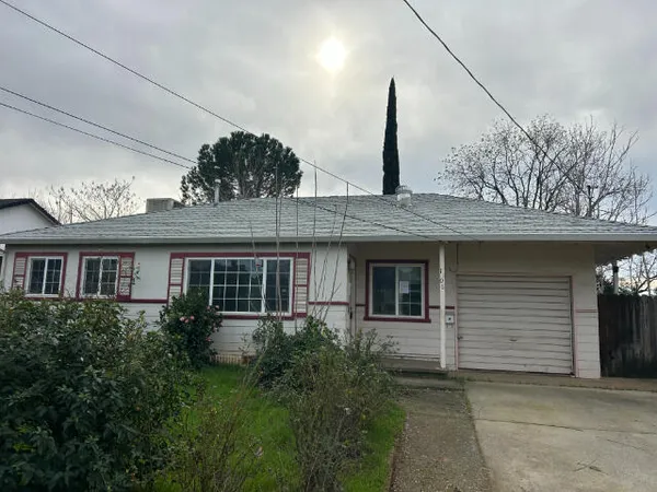 a front view of a house with a garden and garage