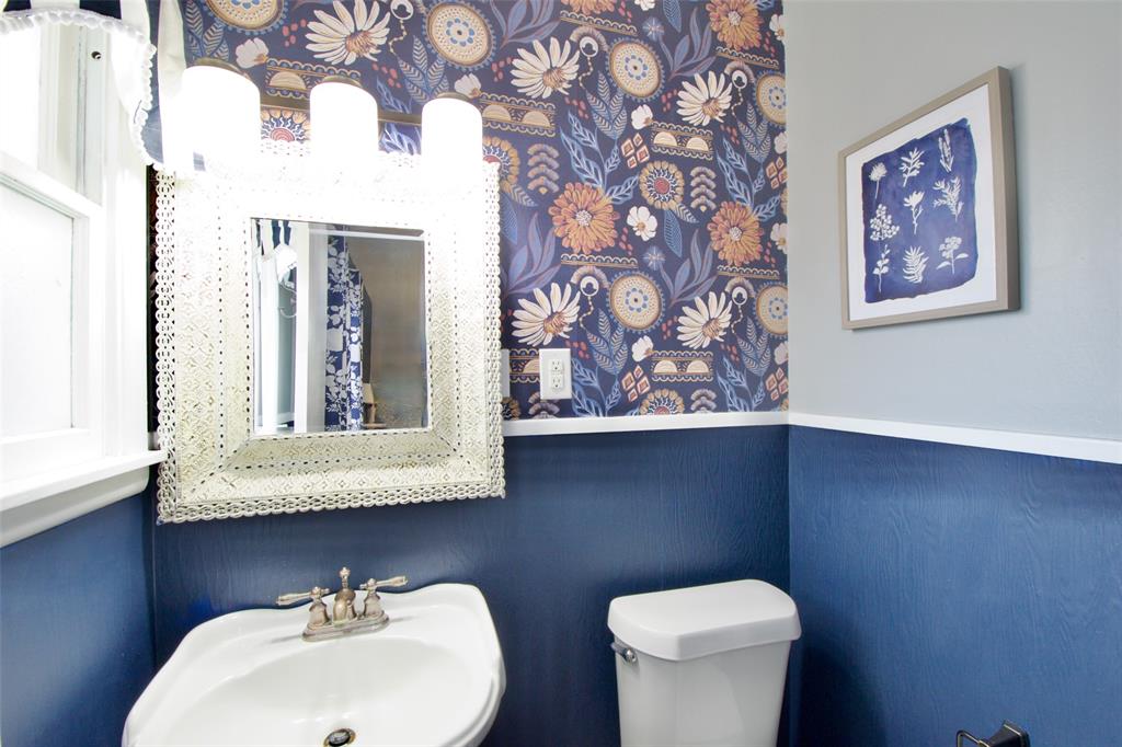 1307 North 65th Street Waco, TX 76710 - Photo 18 of 35 a bathroom with a toilet sink and mirror