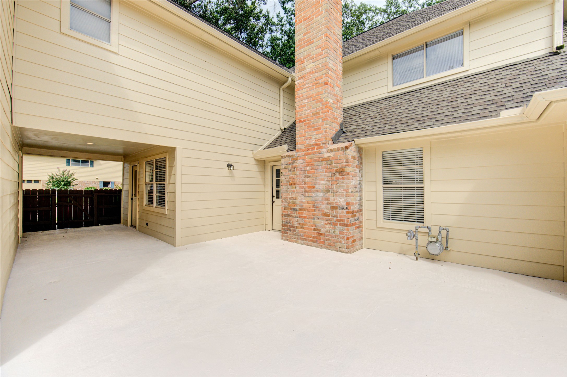 9115 Taidswood Drive Spring, TX 77379 - Photo 41 of 45 The covered breeze way connects the laundry room and kitchen to the garage which makes it nice on rainy day not to get wet! The covered area is also large enough for a small patio table and chairs.