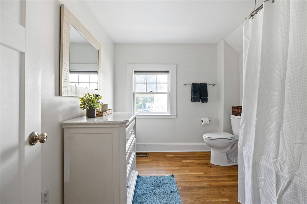 80 Washington Street Stoneham, MA 02180 - Photo 14 of 21 a bathroom with a toilet a sink and a window